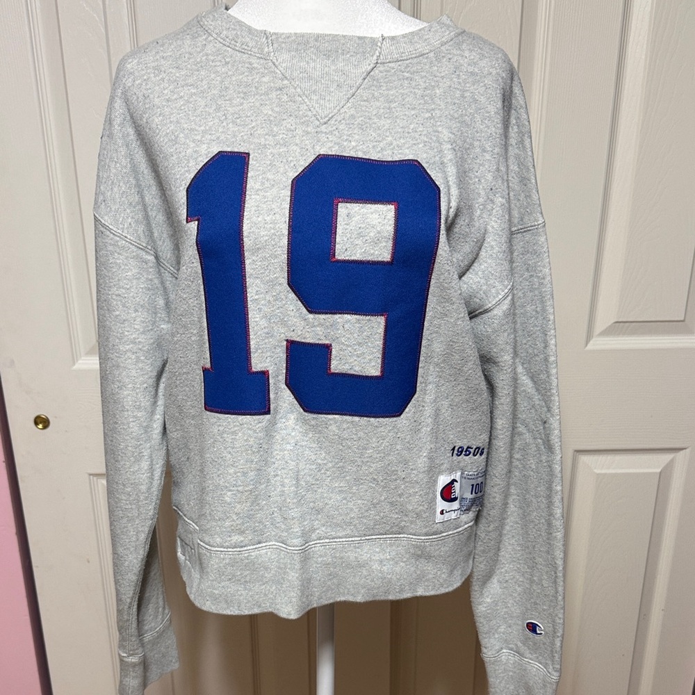 Champion Heather Gray Sweatshirt with Blue '19' and Champion logo on the back.